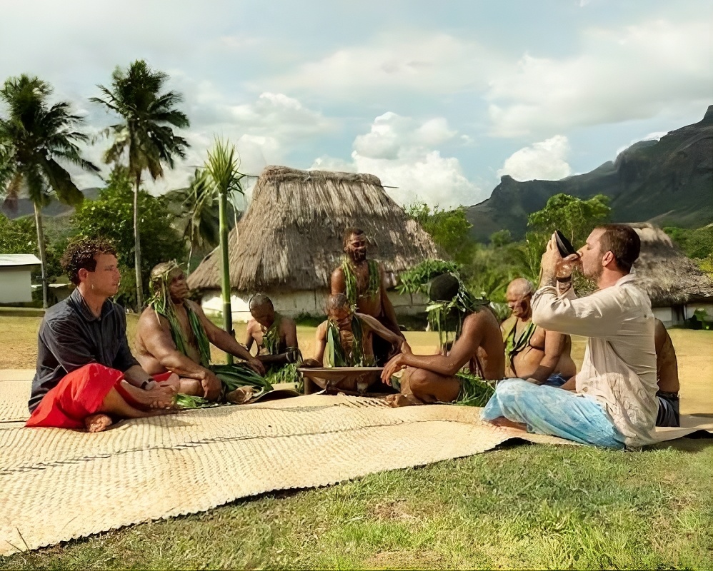 Visitors take part in a traditional kava ceremony with local villagers in Fiji